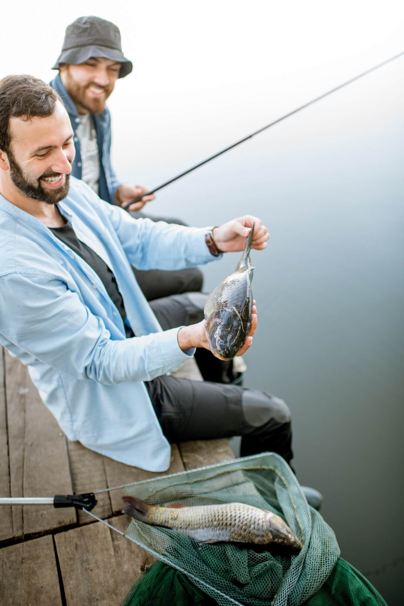 Fishermen with fish on the lake